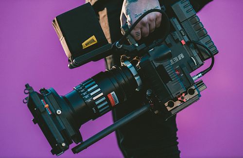 person carrying black camcorder